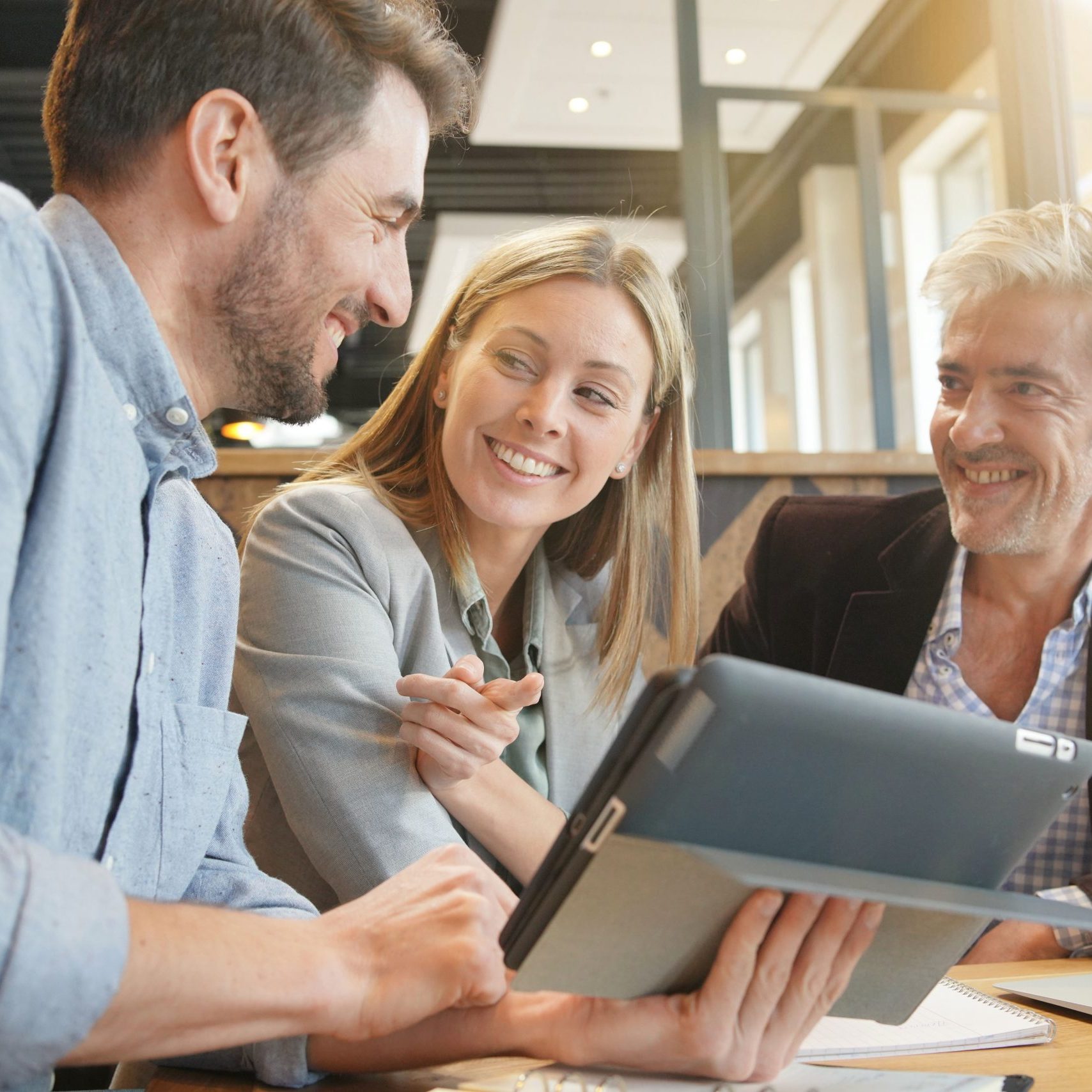 Smiling sales team working through presentation with manager